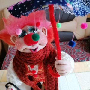 Handmade Rag doll under an umbrella