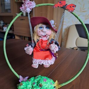 Handmade Rag doll cute girl on a swing