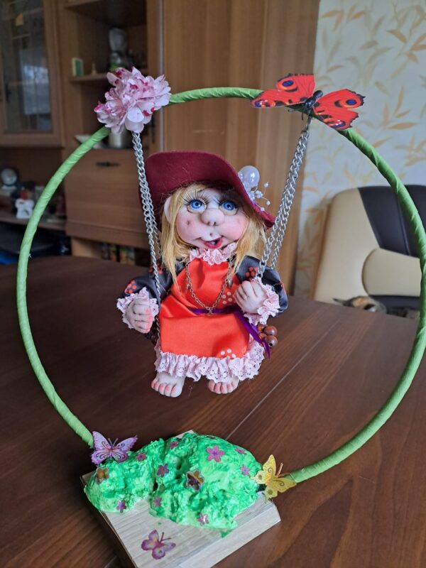 Handmade Rag doll cute girl on a swing